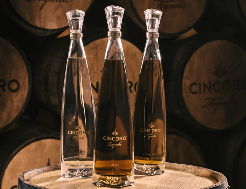 3 expressions of Cincoro are showcased on an oak barrel 